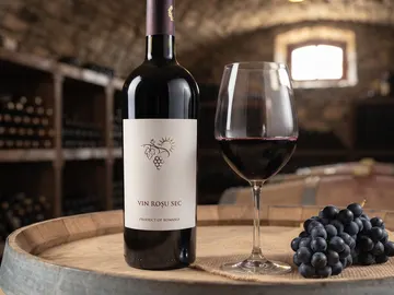 A bottle and glass of Fetească Neagră red wine
